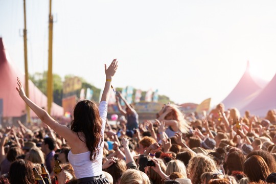 people-with-their-arms-in-air-at-music-festival 540x360